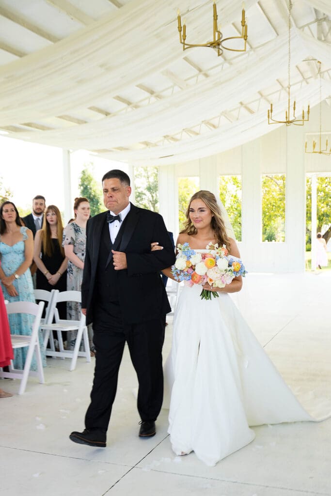 stunning portrait of the bride walking down the aisle