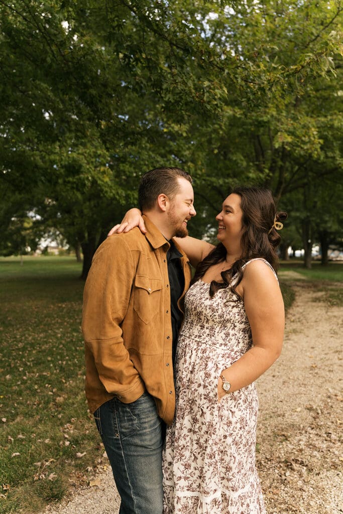cute couple smiling at each other during their photoshoot