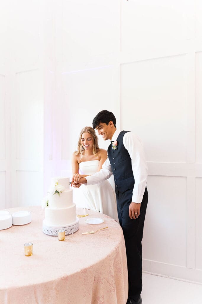 newlyweds cutting their wedding cake