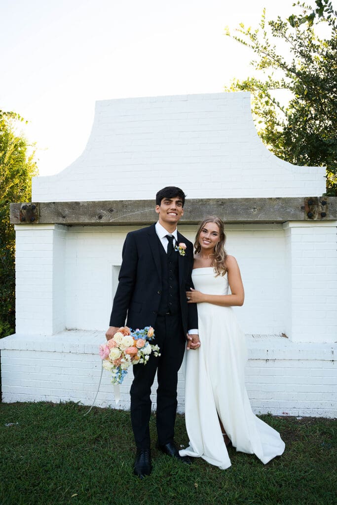 newlyweds smiling at the camera during their photoshoot