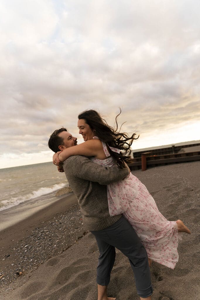 couple dancing at the beach during their session