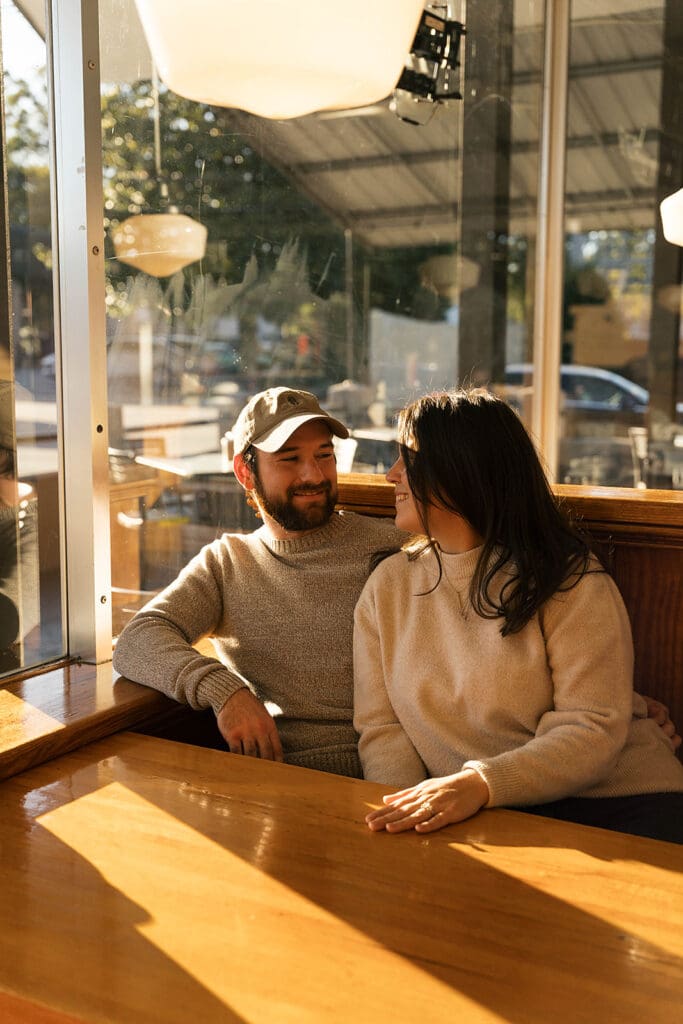 couple smiling at each other during their photoshoot