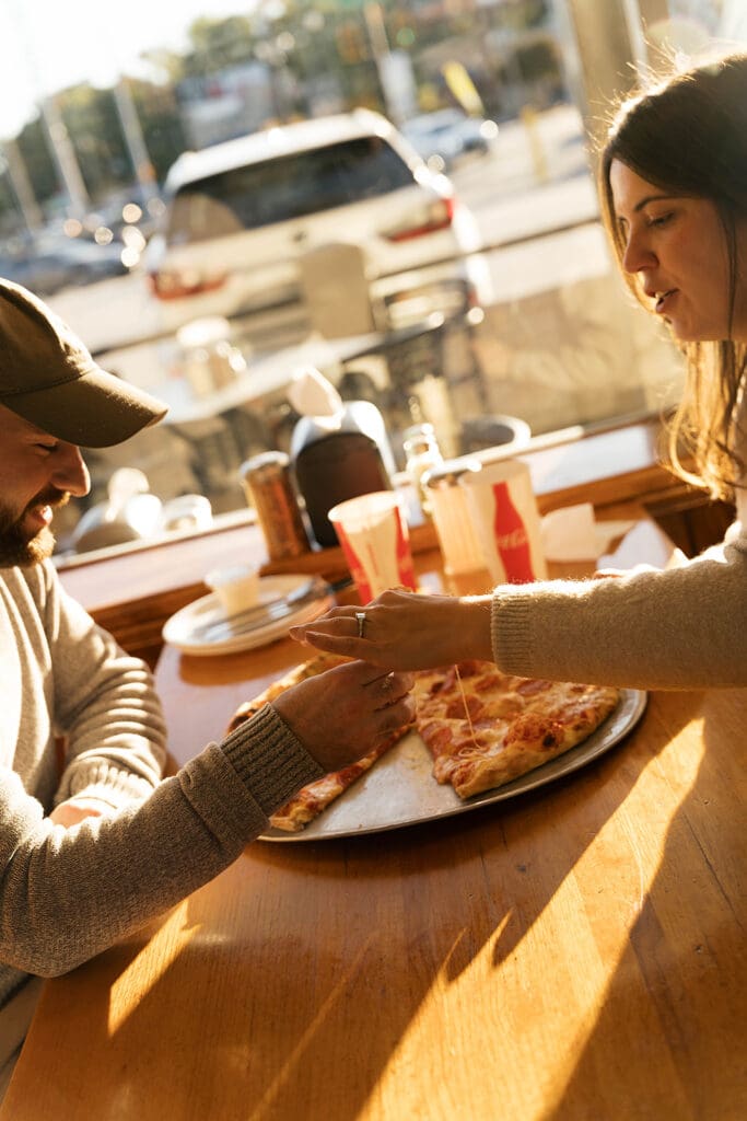 couple celebrating their engagement with pizza