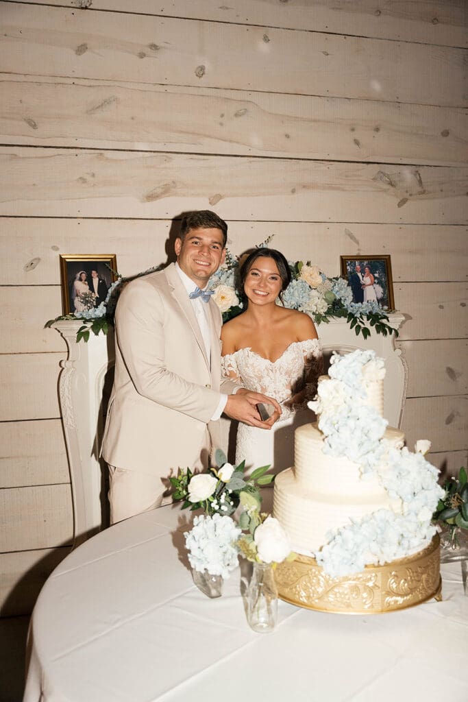 portrait of the newlyweds cutting their wedding cake