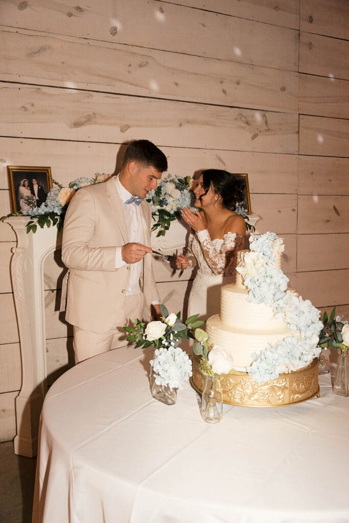 newlyweds trying their wedding cake