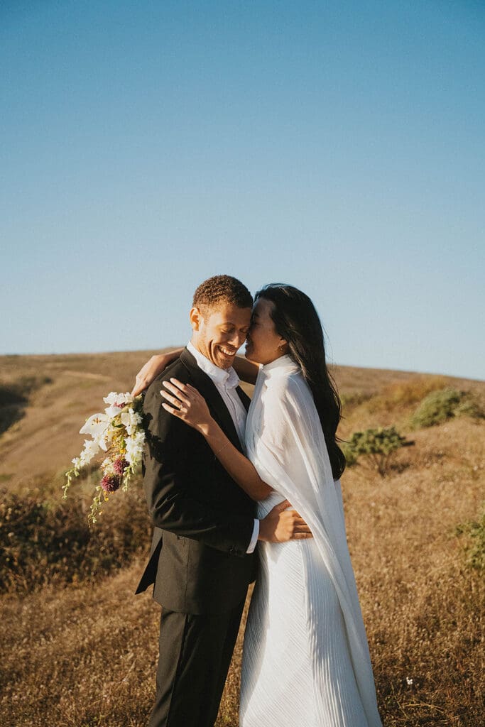 bride kissing the groom on the cheek