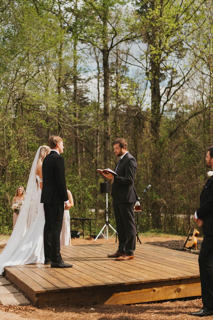 bride and groom holding hands during their ceremony