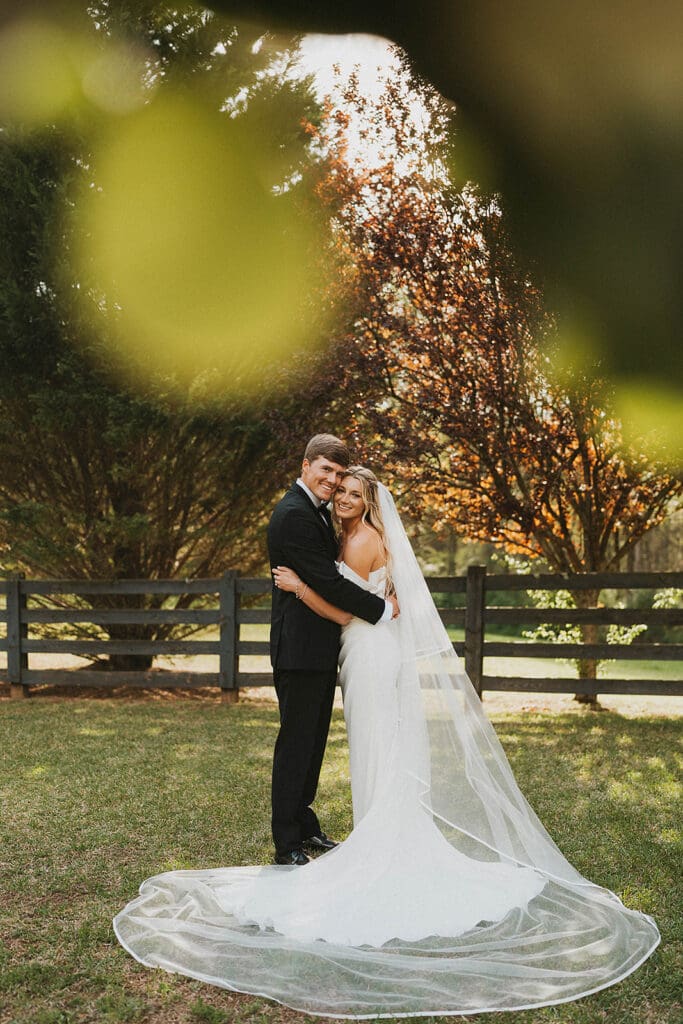 cute picture of the newlyweds smiling at the camera