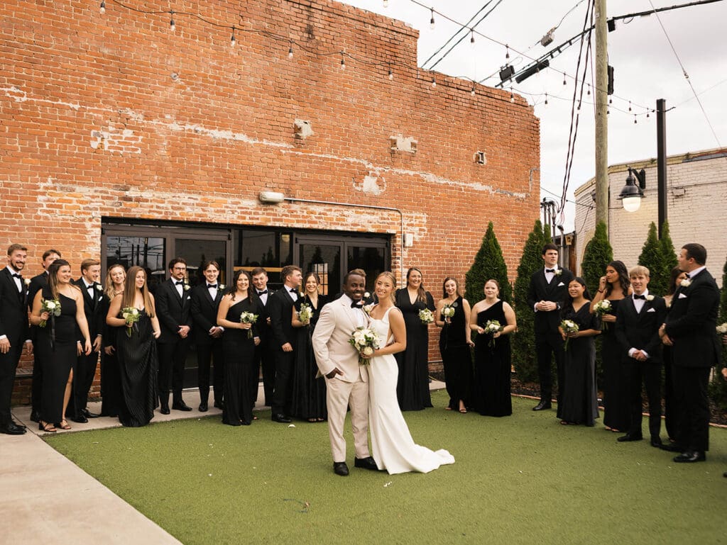 cute picture of the bride and groom with their bridal parties