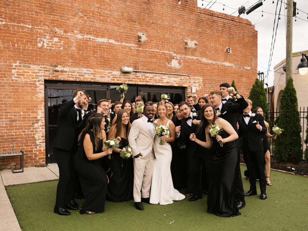 portrait of the newlyweds with their friends