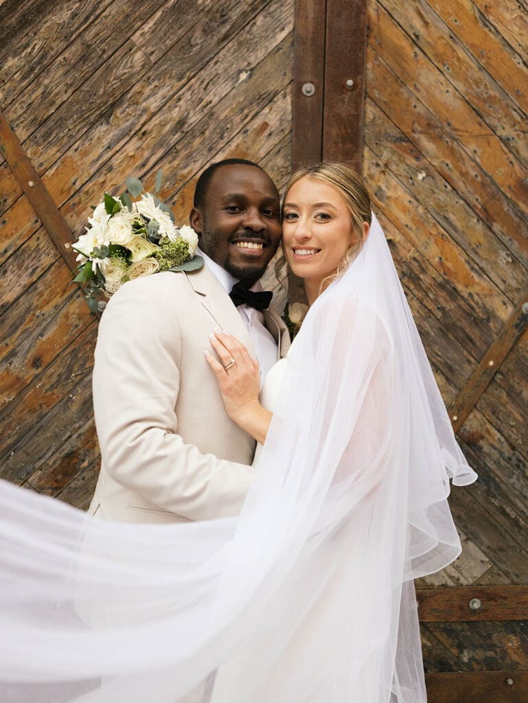couple smiling at the camera during their bridal portraits