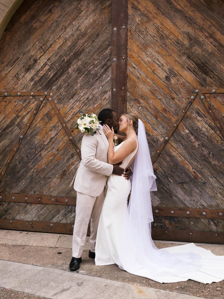 cute portrait of the bride and groom kissing