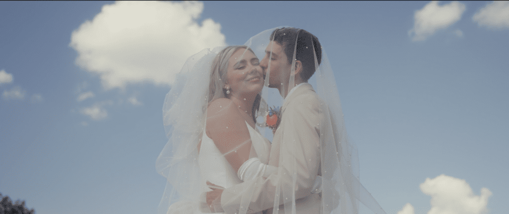 groom kissing the bride on the cheek