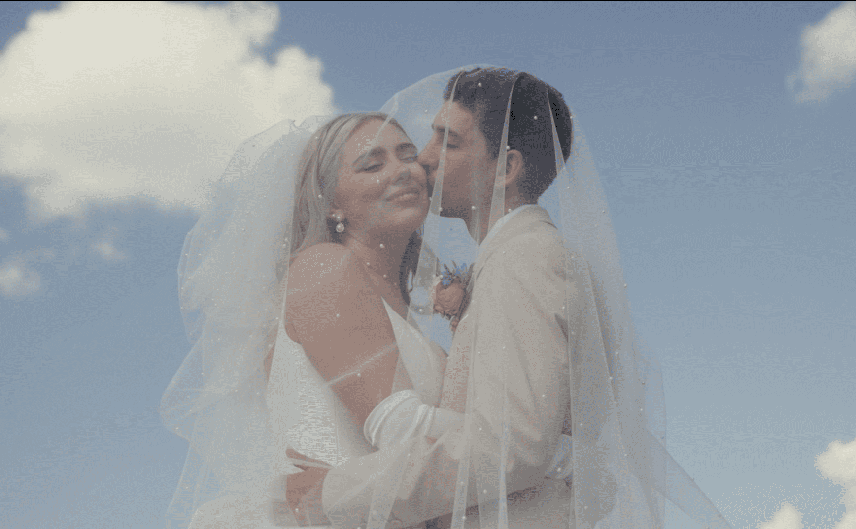 groom kissing the bride on the cheek
