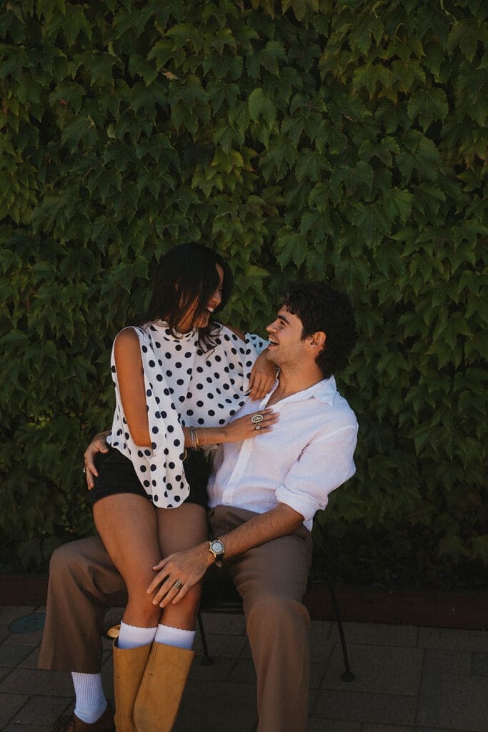 newly engaged couple smiling at each other