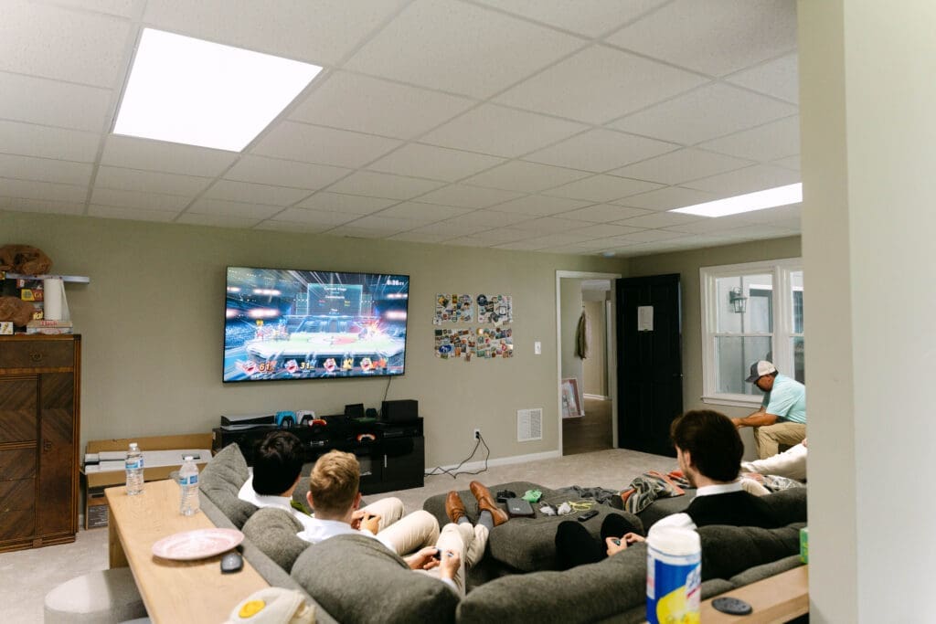 groomsmen relaxing with video games while getting ready for the wedding